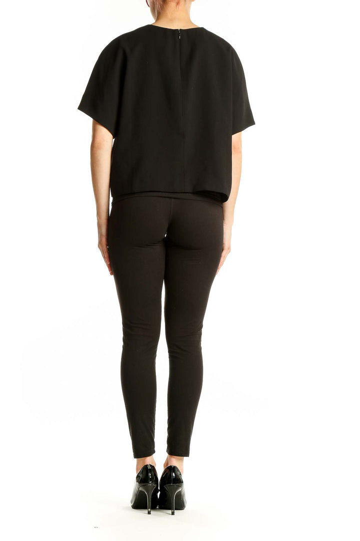 Back view of J.Crew black polyester oversized crop top showing high-low hemline