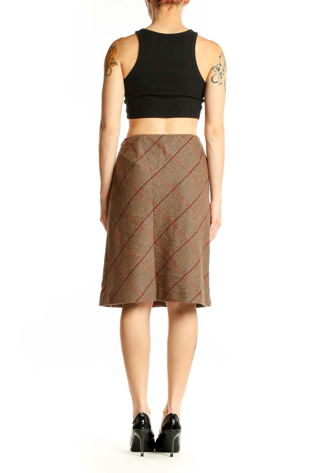 Side view of model wearing Ann Taylor LOFT brown plaid pencil skirt with black top