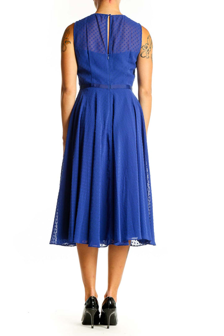 Back view of royal blue Hobbs London midi dress showing polka dot pattern and flowy skirt