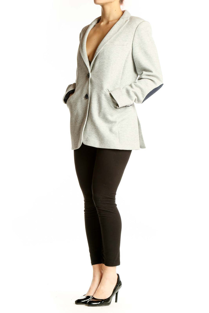 Front view of light gray Tommy Hilfiger blazer with notched lapels and two-button closure