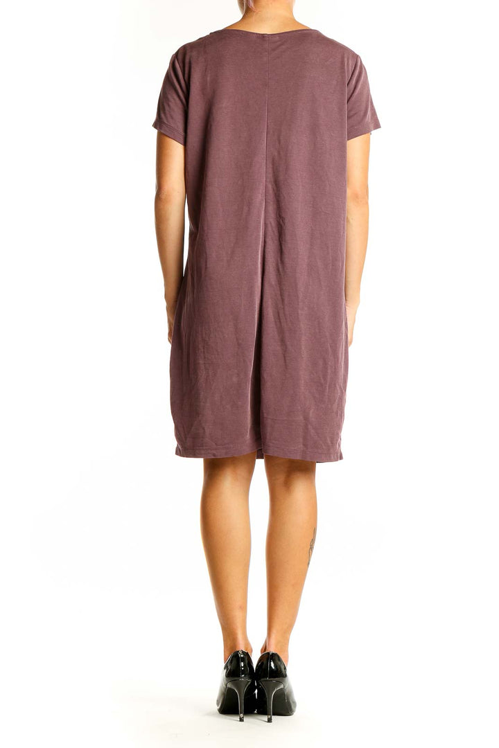 Side view of Tahari mauve t-shirt dress showing knee-length cut and flowy silhouette