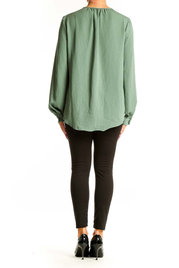 Side view of Nine West sage green blouse showing flowing silhouette