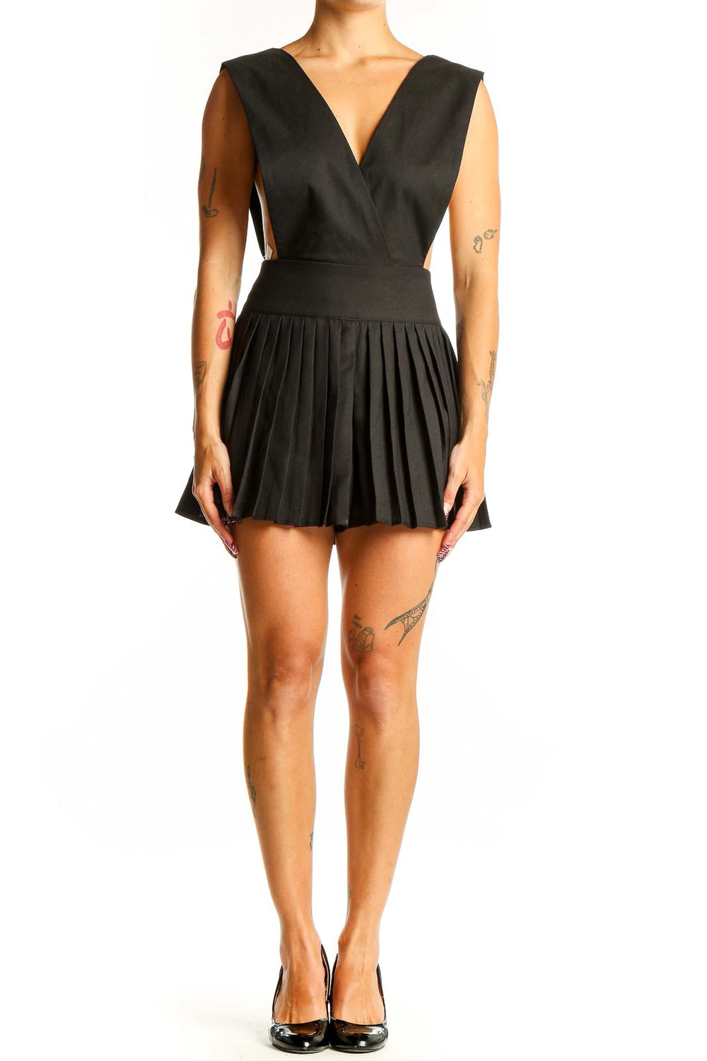 Front view of black pleated sleeveless romper with V-neckline