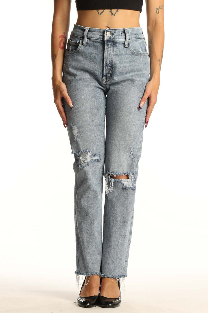 Front view of Mother light blue distressed straight leg jeans on model