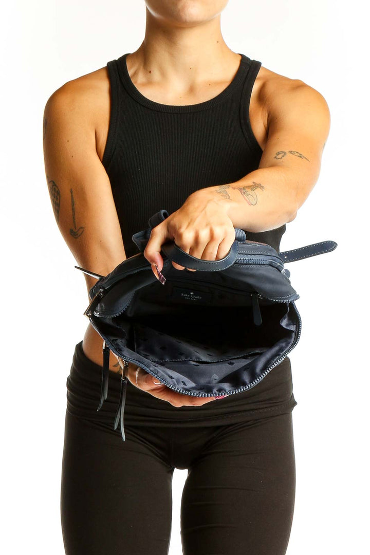 Back view of Kate Spade navy nylon backpack worn by model