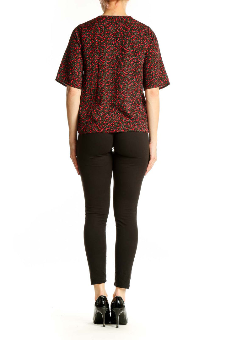 Side view of NastyGal red floral print blouse showing elbow-length sleeves