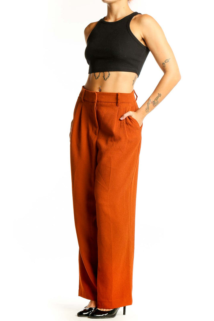 Front view of burnt orange wide-leg trousers from Nine West