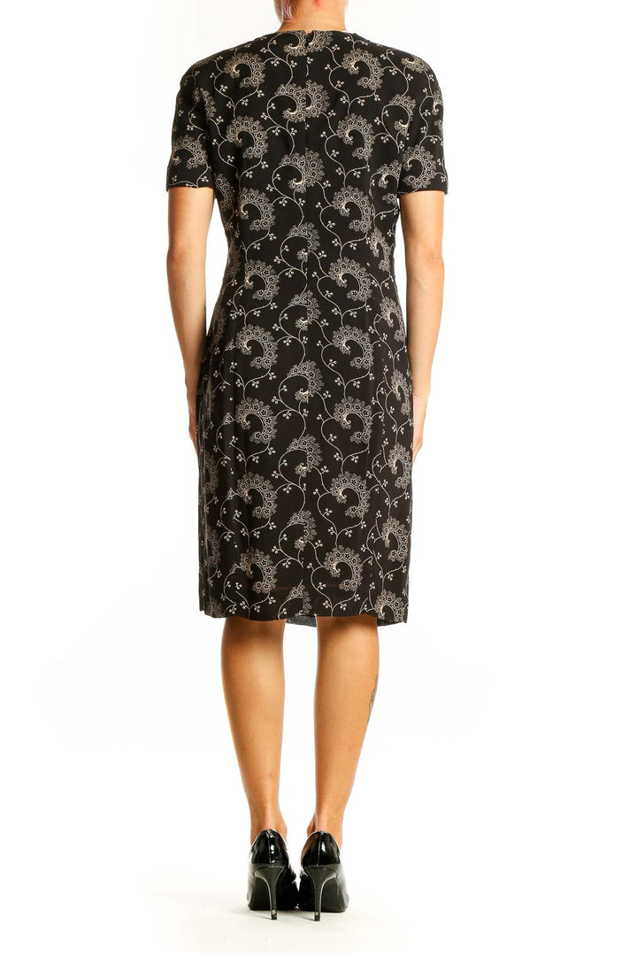 Side view of Tahari black sheath dress showing embroidery detail