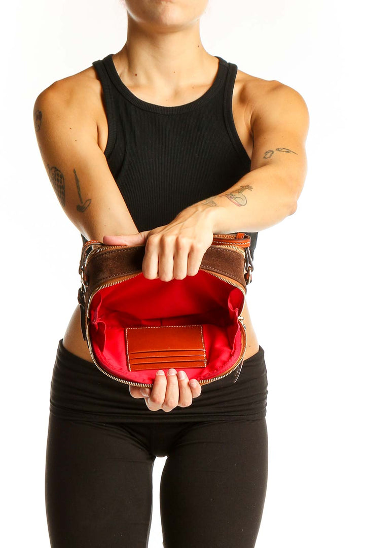 Side view of Dooney & Bourke brown suede leather crossbody bag worn by model