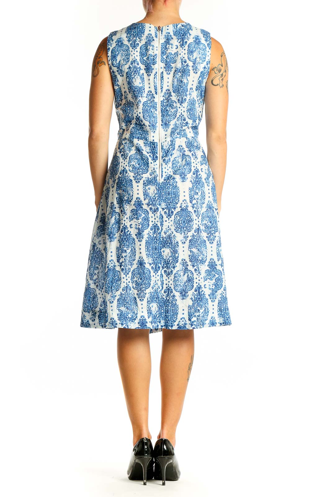 Side view of NYDJ blue and white floral sleeveless dress showing pleated skirt