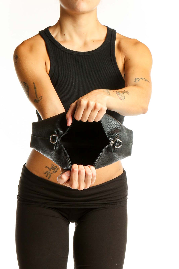Side view of black NEWBELLA leather clutch purse held against body
