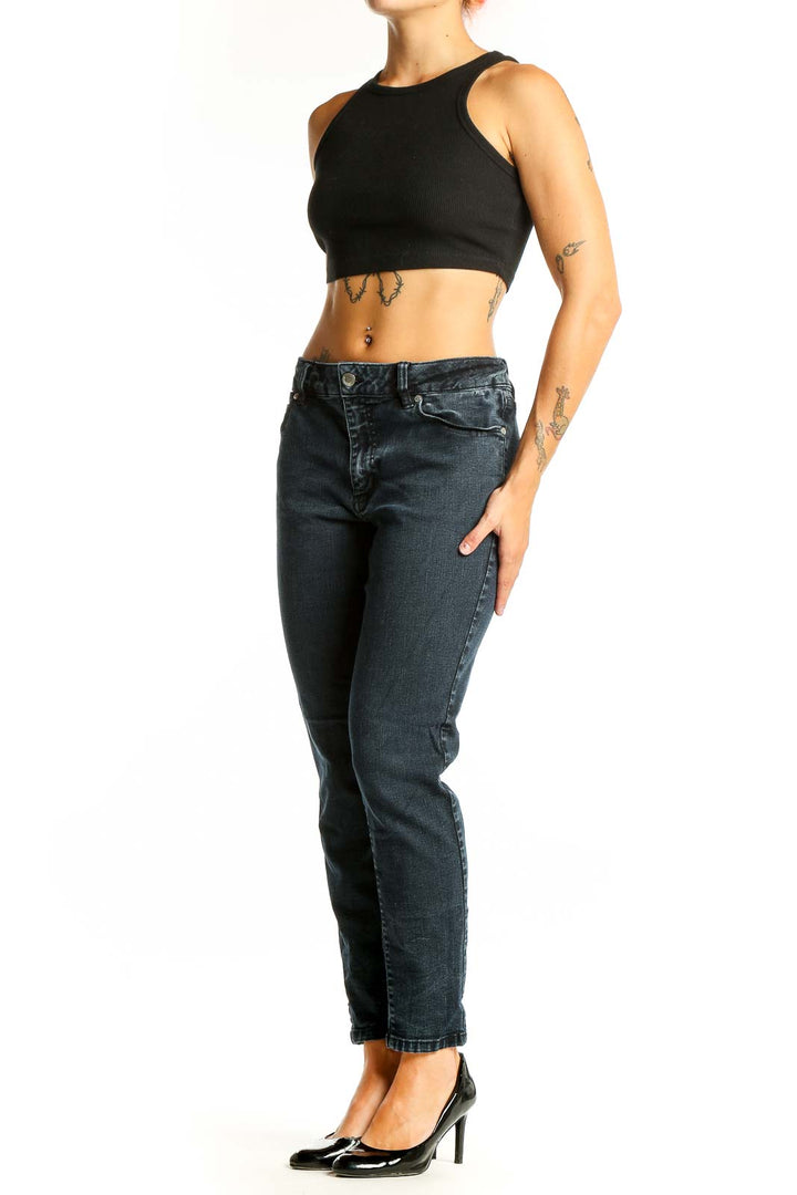 Front view of Tahari dark blue tapered denim jeans on model