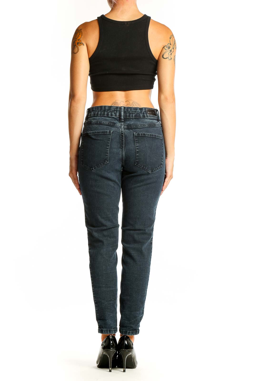 Back view of Tahari dark blue tapered denim jeans on model