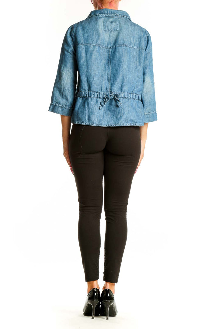 Side view of Ann Taylor LOFT blue cropped jacket showing 3/4 sleeves and elastic waistband