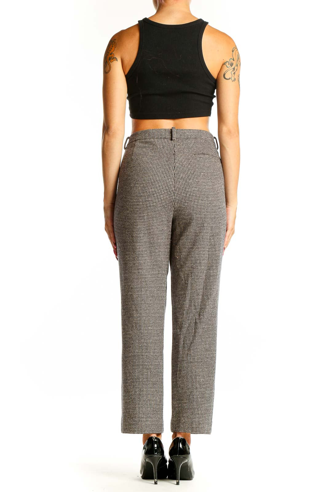 Side view of woman wearing Theory gray houndstooth trousers with black top