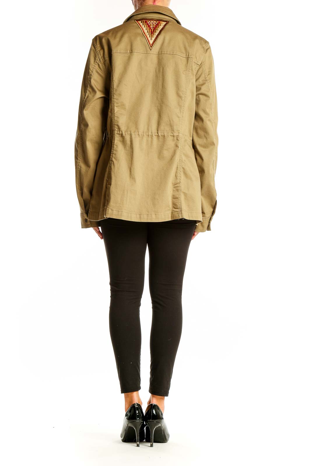 Side view of woman wearing Orvis khaki military-style utility jacket