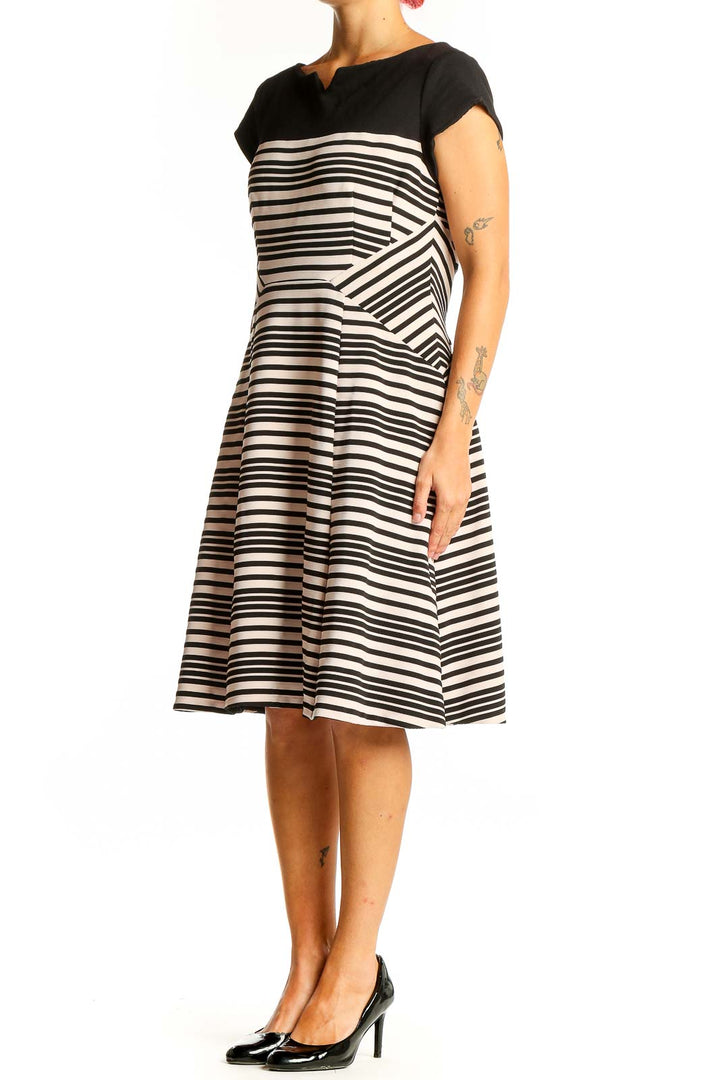 Front view of Nanette Lepore black and white striped fit-and-flare dress with boat neckline