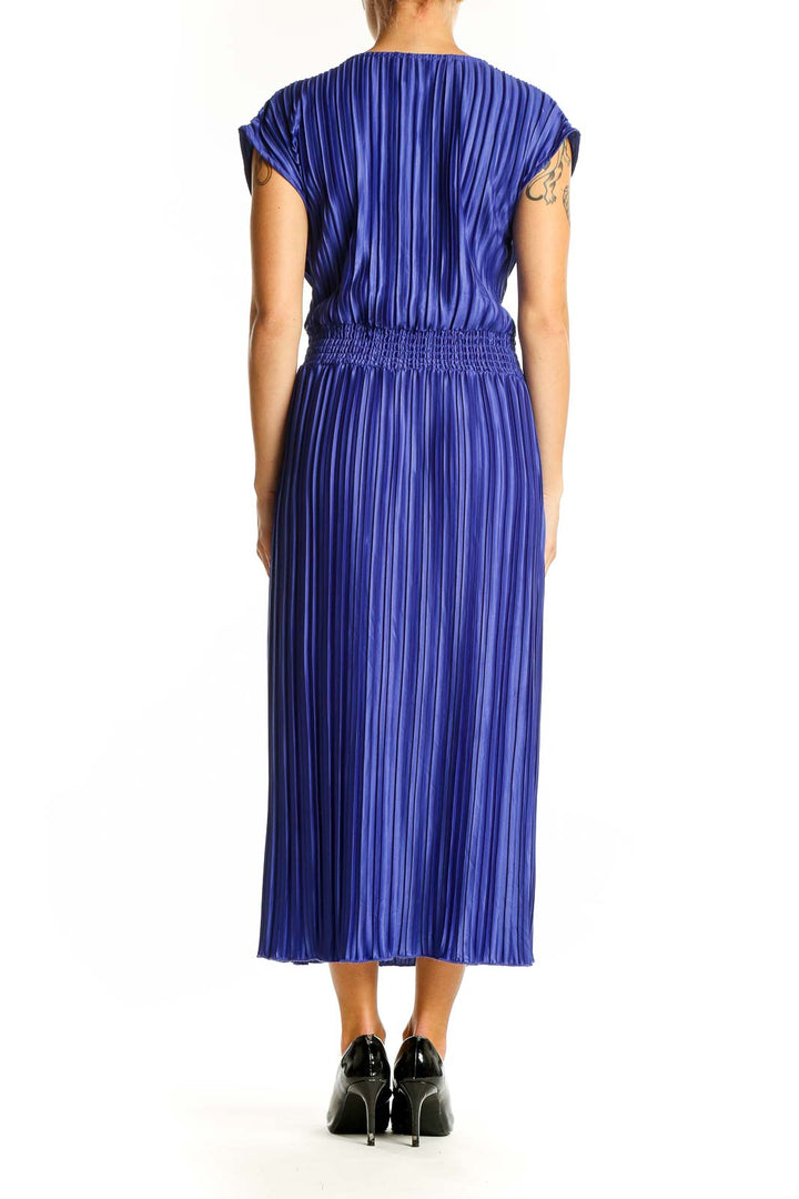 Side view of blue pleated DKNY midi dress showing full length and silhouette
