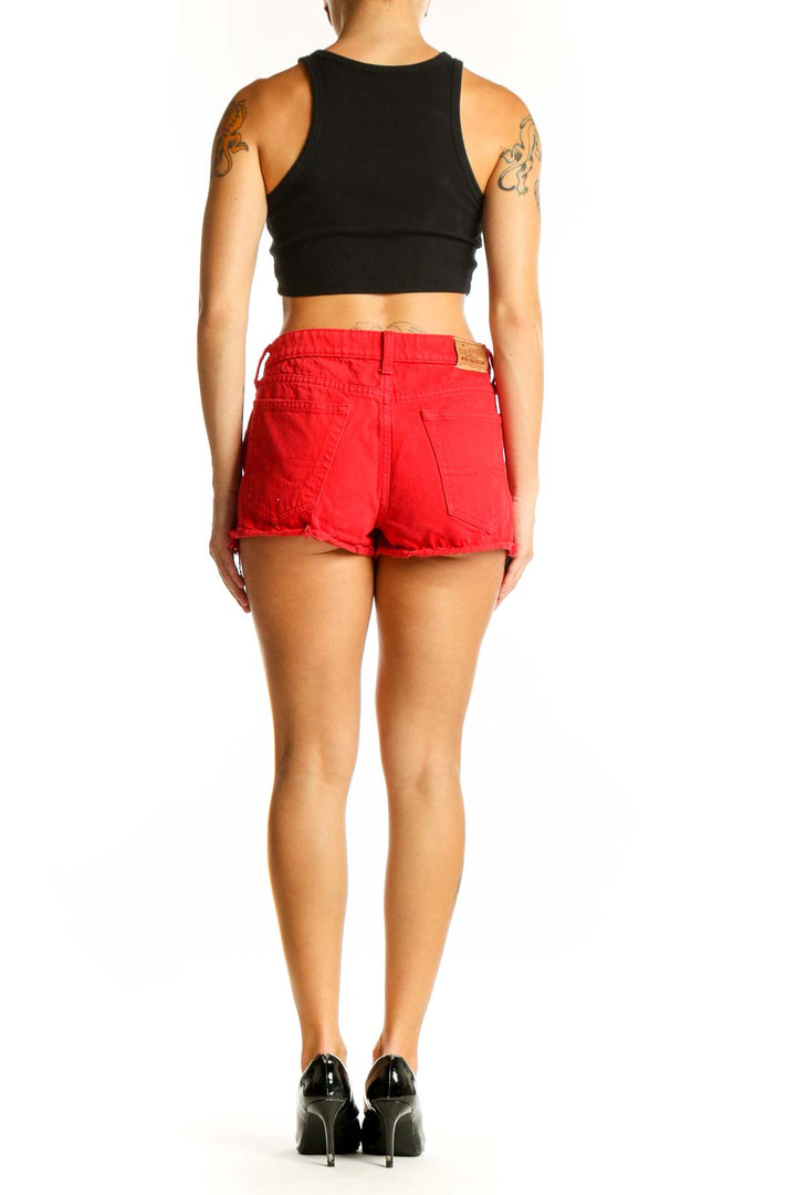 Side view of woman wearing red Lucky Brand cotton shorts with black top