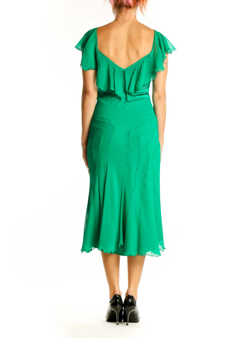Side view of green silk Diane von Furstenberg cocktail dress showing pleated bodice and midi length