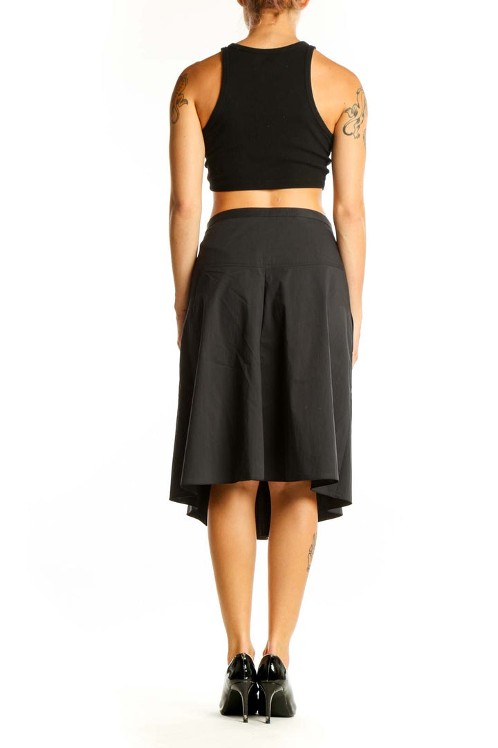 Side view of Moschino Cheap And Chic black pleated midi skirt on model