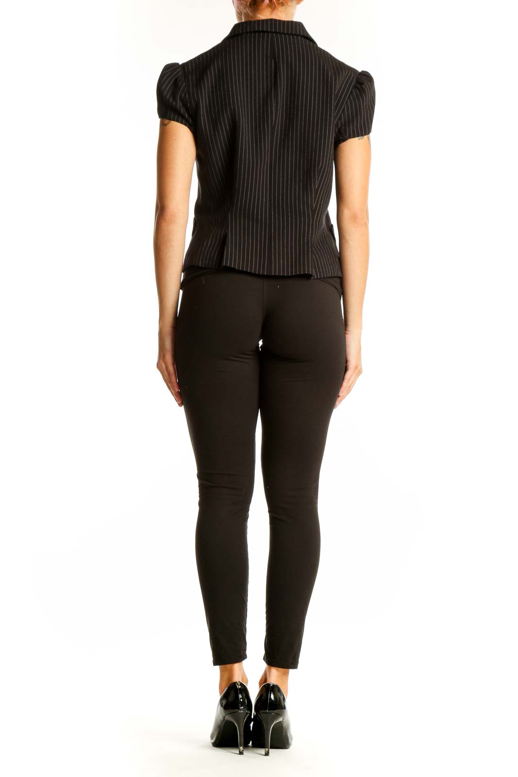 Side view of model wearing BCBG MaxAzria black pinstripe short-sleeve blazer with black pants