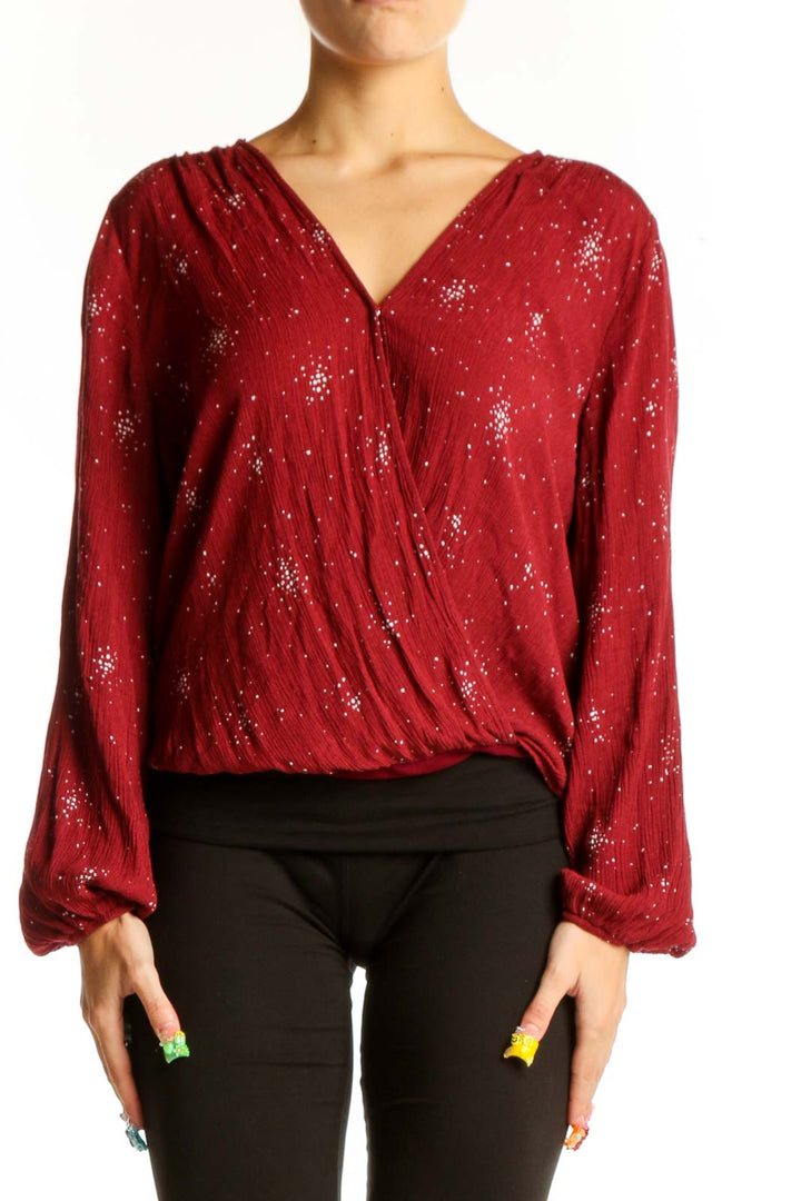 Front view of red sparkly wrap blouse with long sleeves