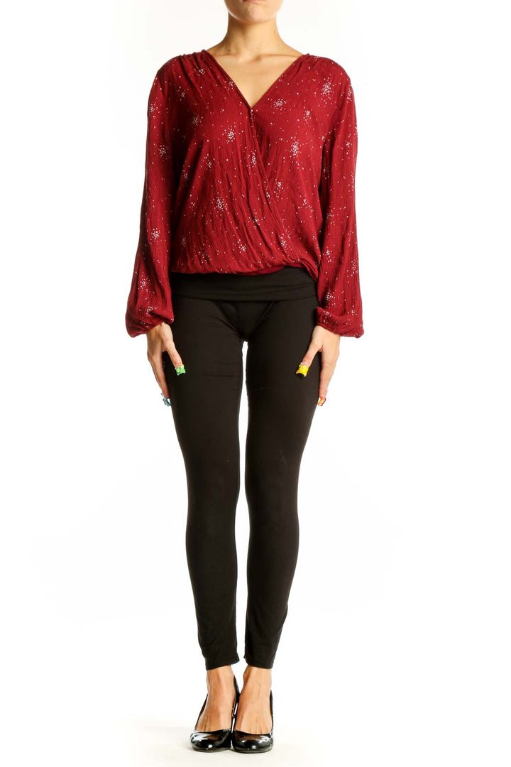 Front view of red sparkly wrap blouse with long sleeves