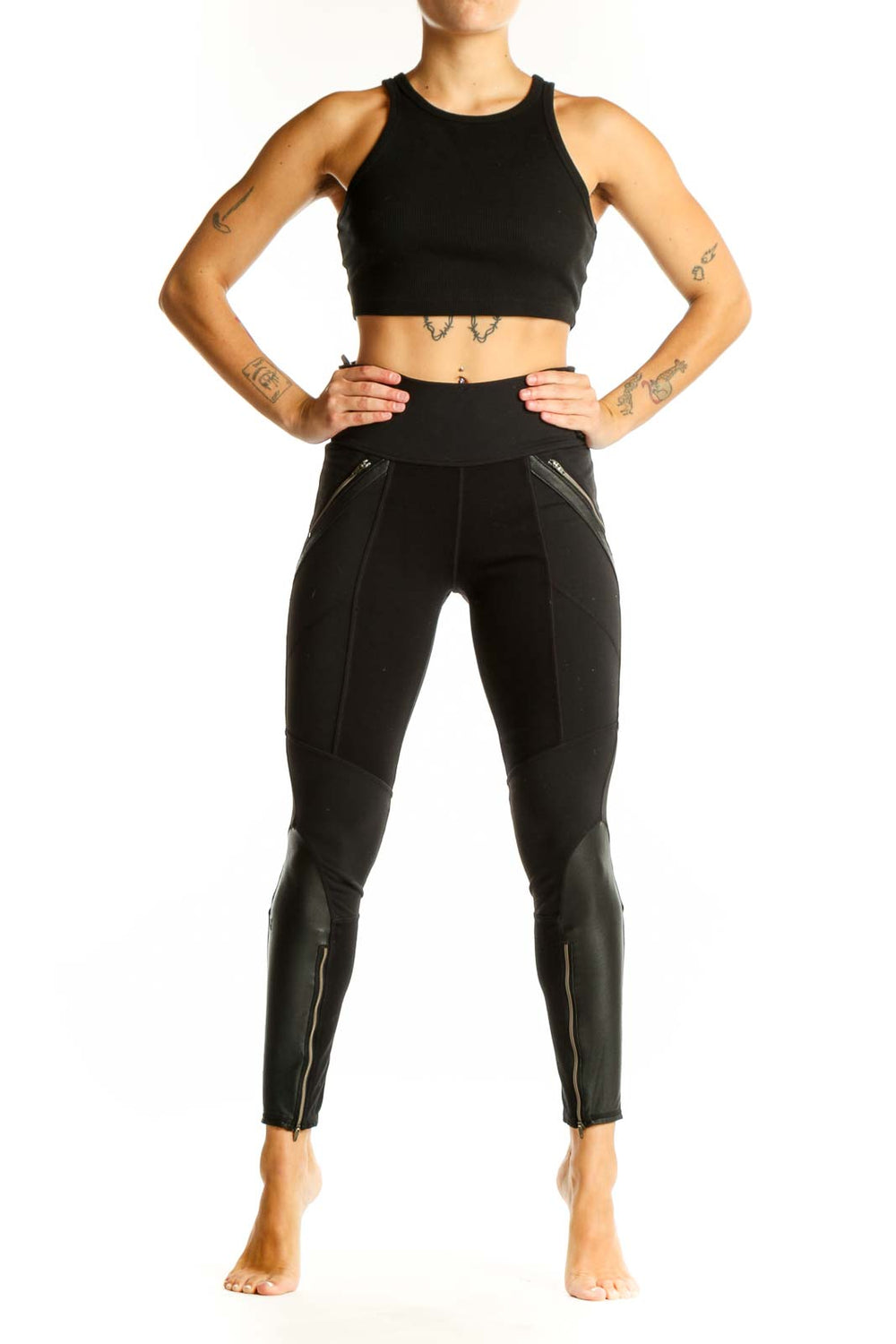 Front view of black Athleta athletic leggings with zipper pockets