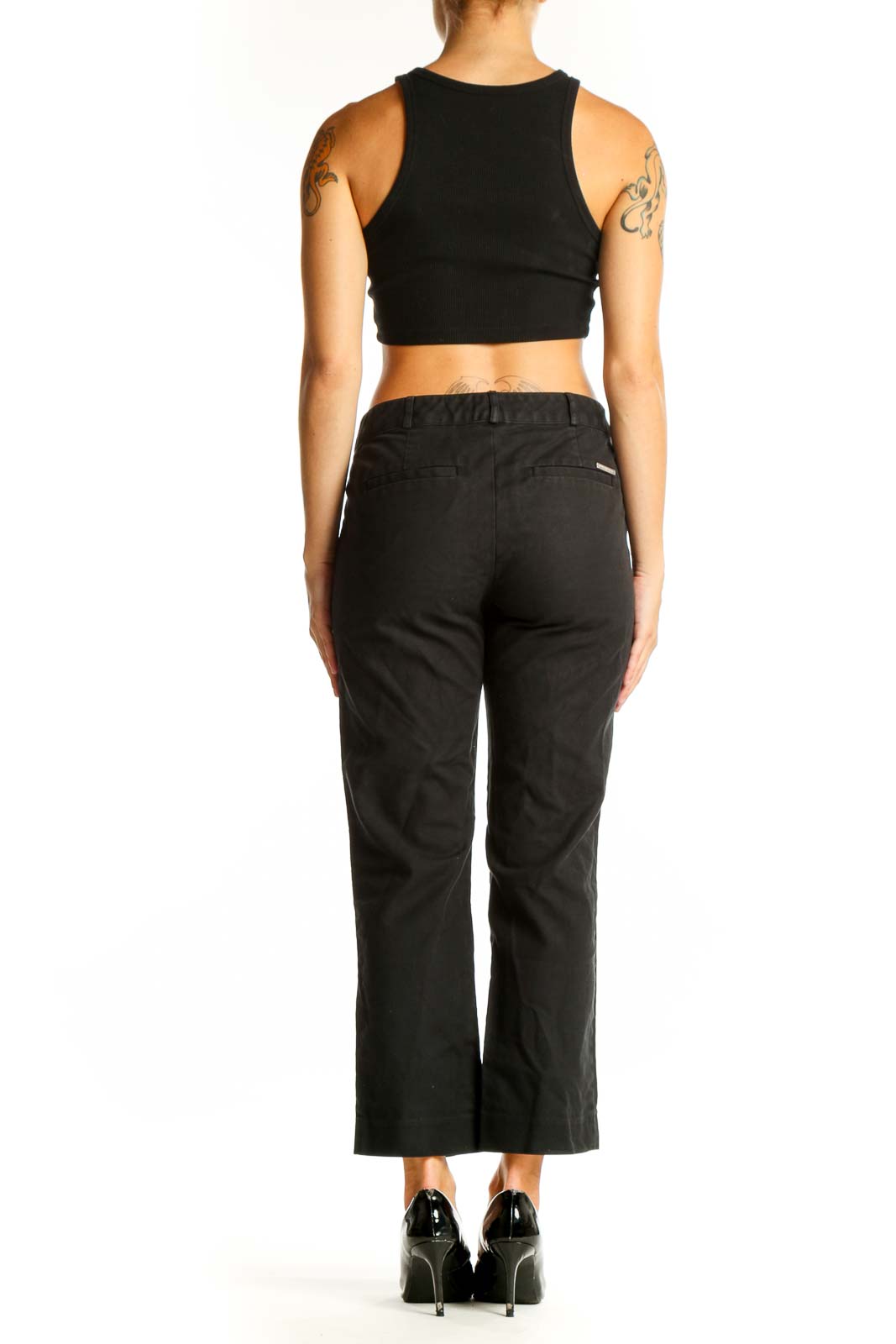 Side view of woman wearing MICHAEL Michael Kors black cropped dress pants