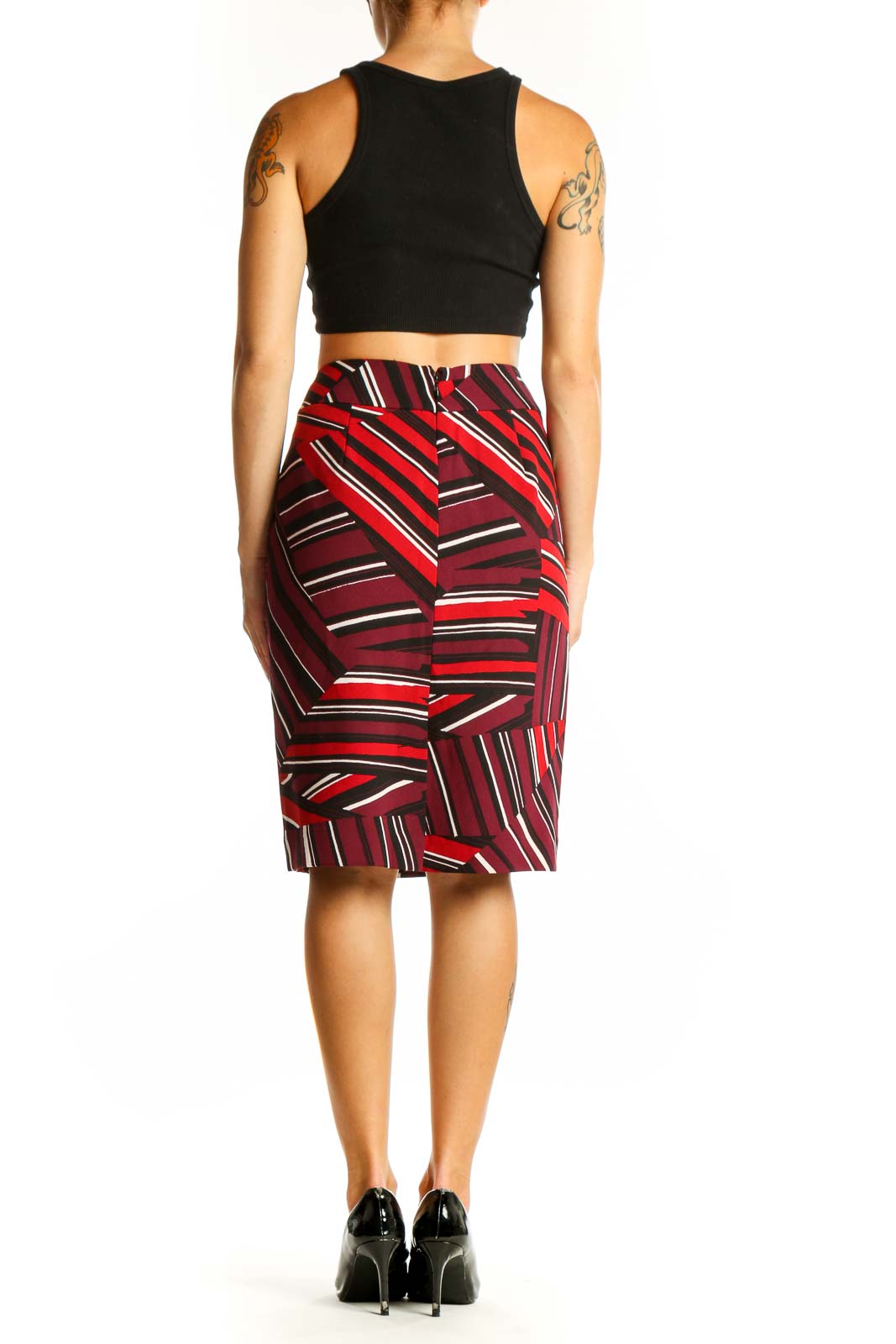 Side view of Nine West red striped pencil skirt on model with black top