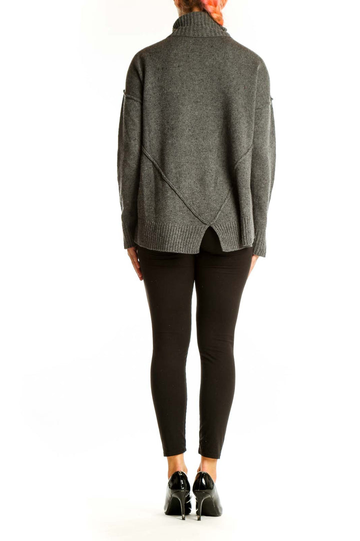 Side view of gray MICHAEL Michael Kors oversized turtleneck sweater showing side slit