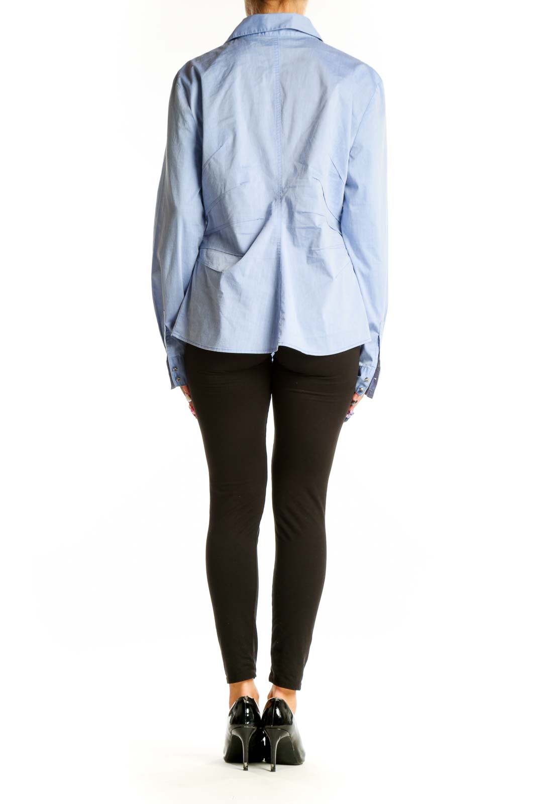 Side view of 7th Avenue light blue button-up shirt worn with black pants