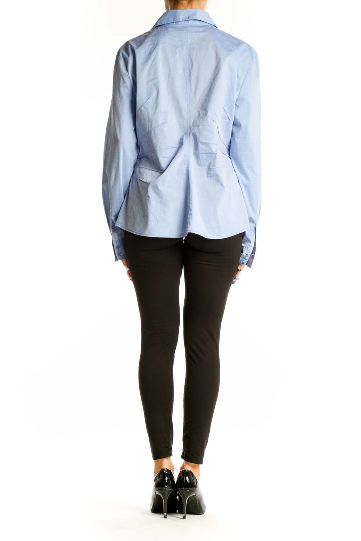 Side view of 7th Avenue light blue button-up shirt worn with black pants