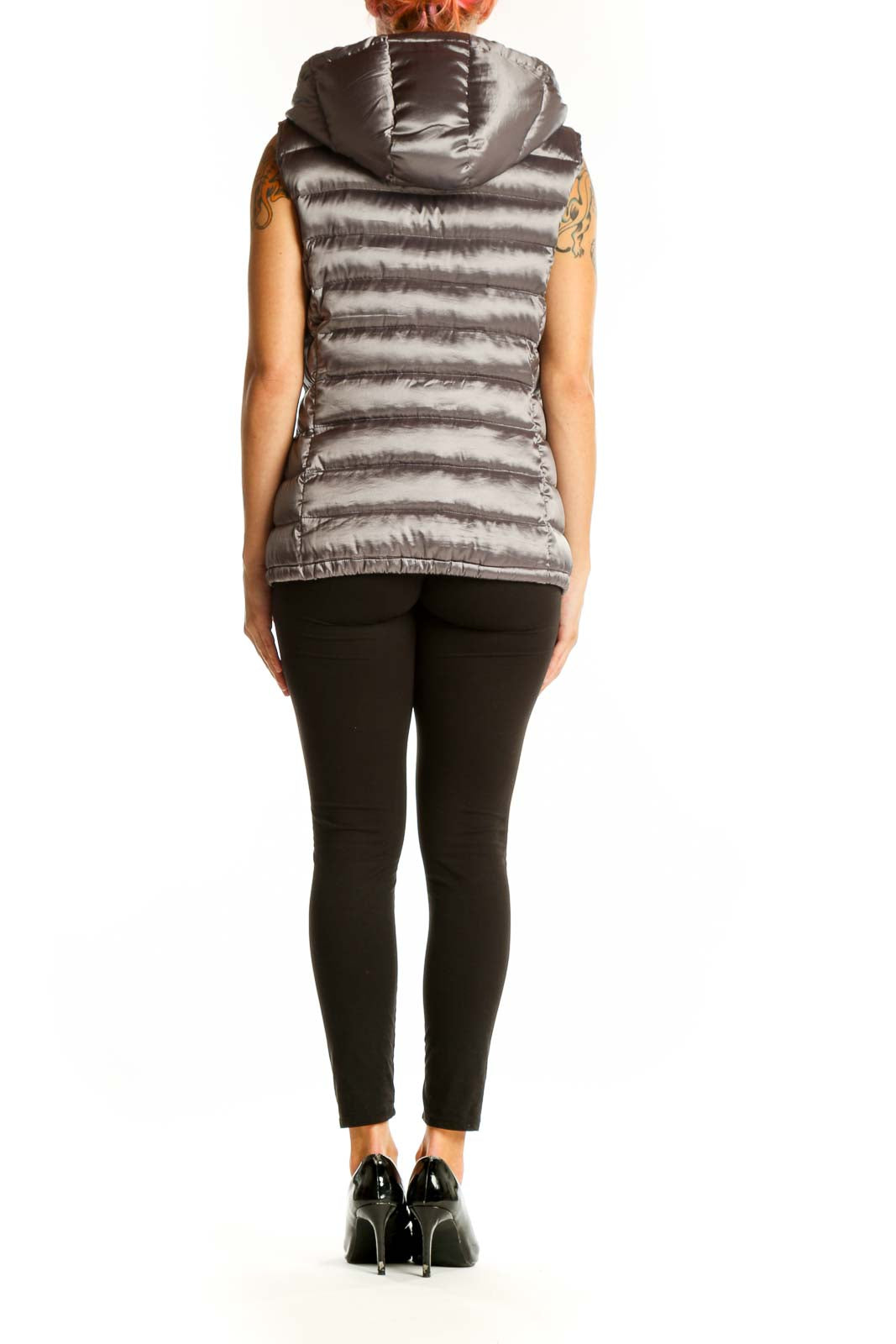 Side view of woman wearing silver Bernardo quilted puffer vest