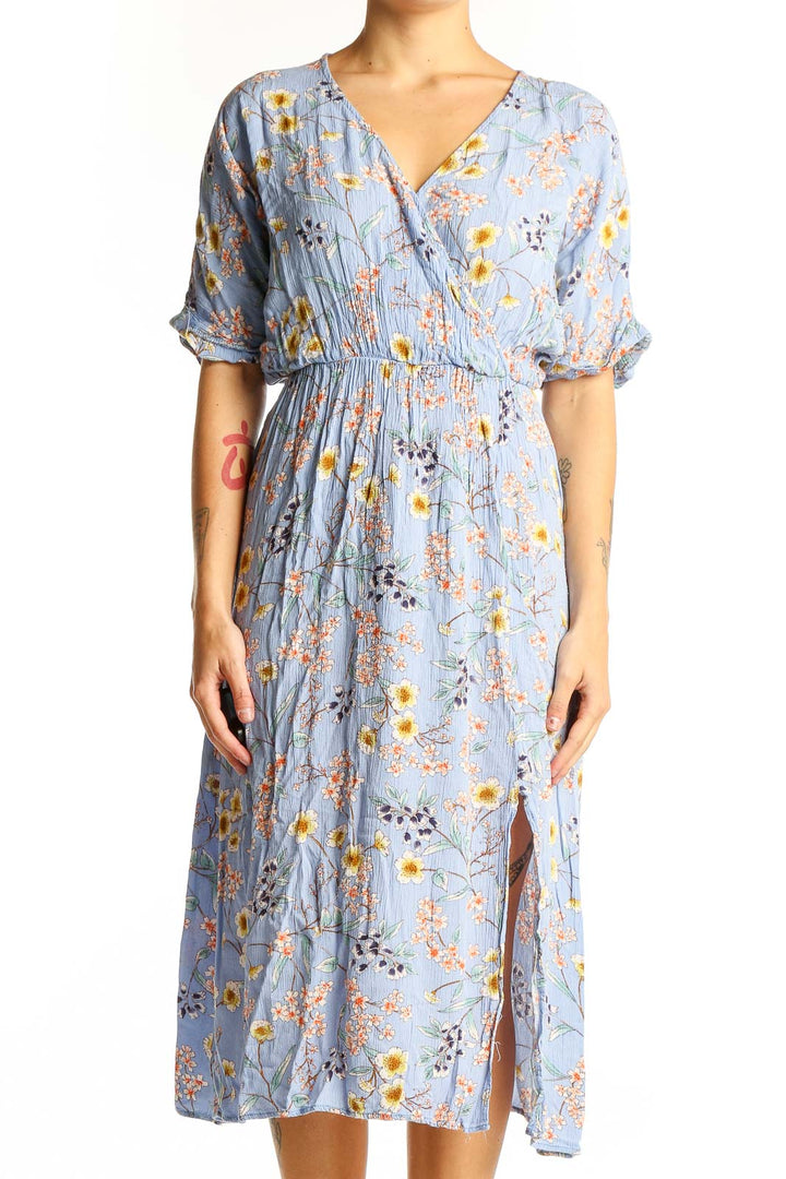 Front view of All in Favor blue floral wrap midi dress with yellow and pink flowers
