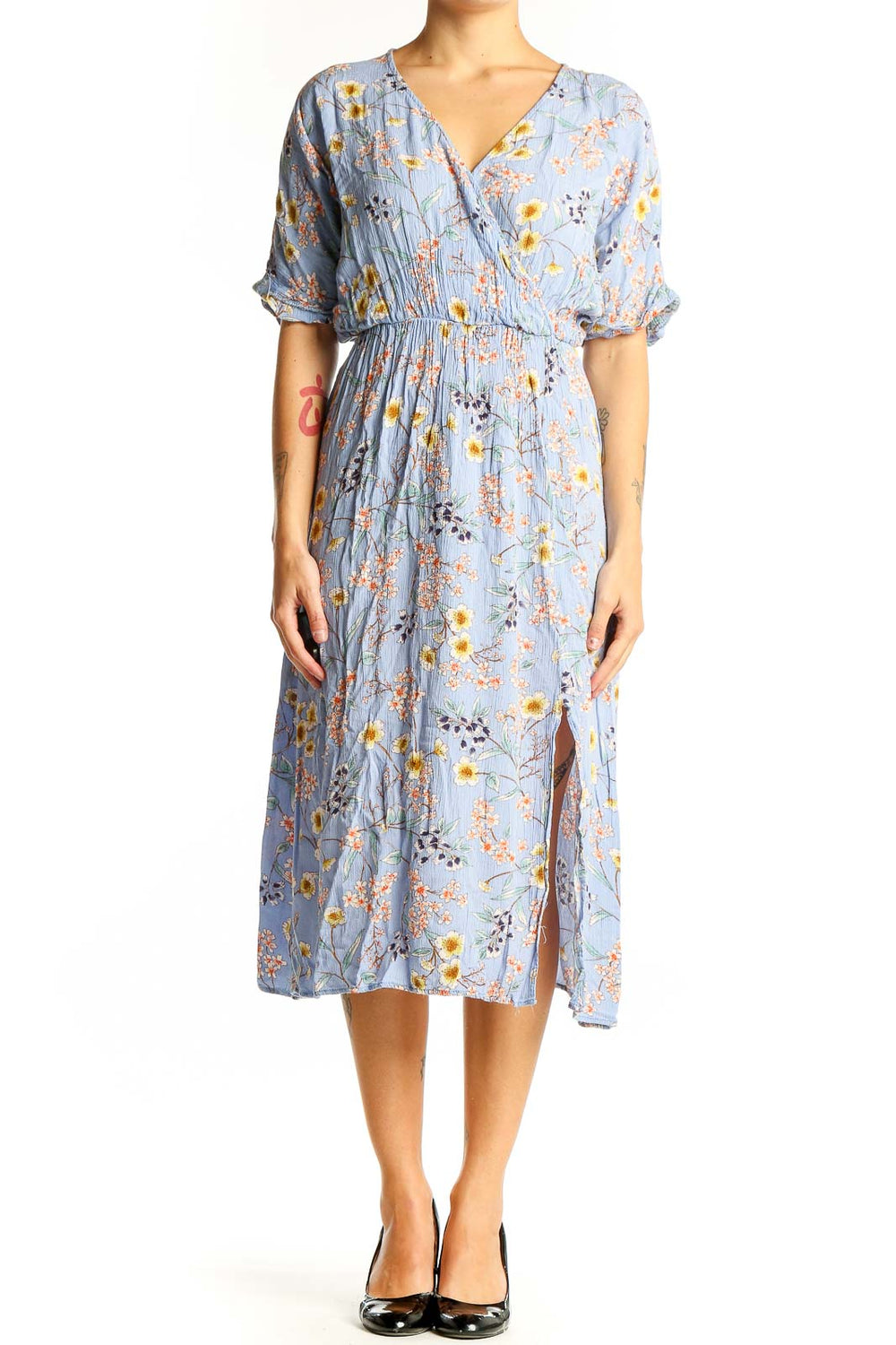 Front view of All in Favor blue floral wrap midi dress with yellow and pink flowers