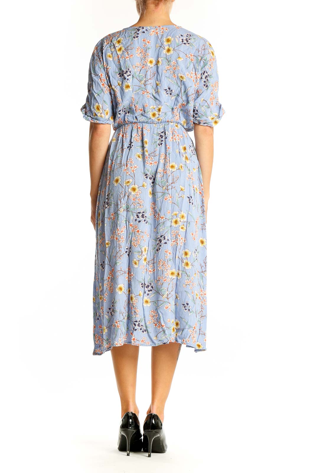 Side view of All in Favor blue floral wrap midi dress showing side slit and puff sleeves