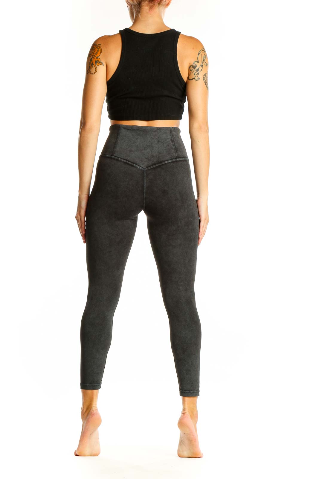 Side view of Athleta black crop top and charcoal gray high-waisted leggings activewear set