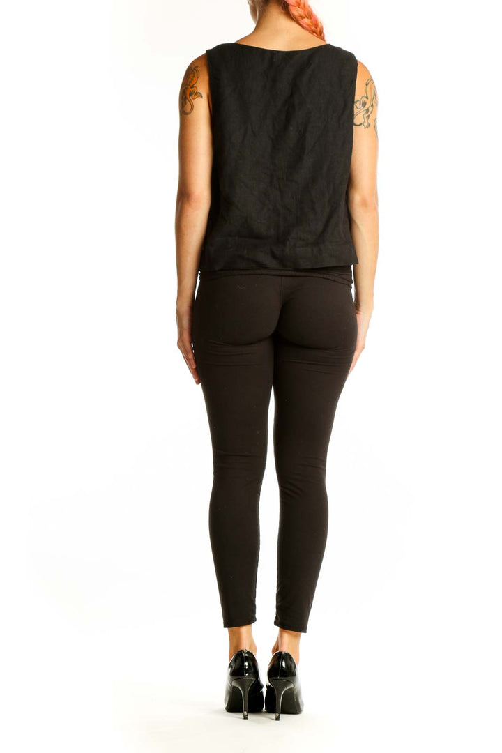 Side view of black linen sleeveless top showing cropped length
