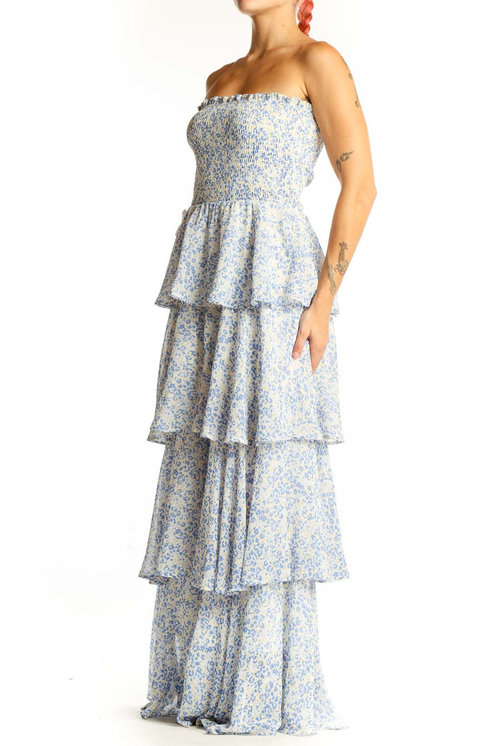 Front view of fab'rik blue floral tiered strapless maxi dress