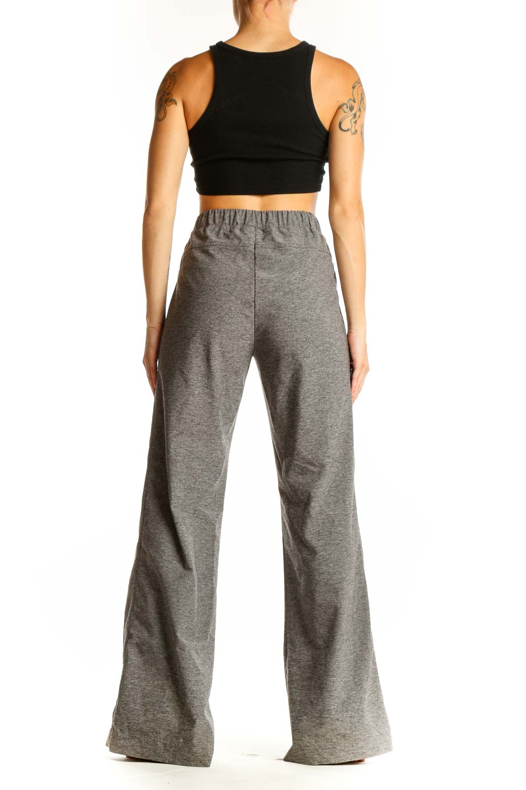 Side view of woman wearing gray wide-leg activewear pants by Derek Lam 10C - Athleta
