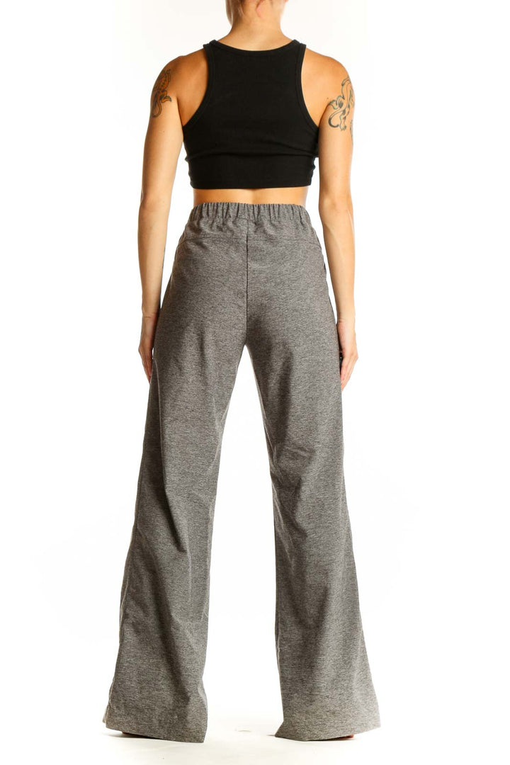 Side view of woman wearing gray wide-leg activewear pants by Derek Lam 10C - Athleta