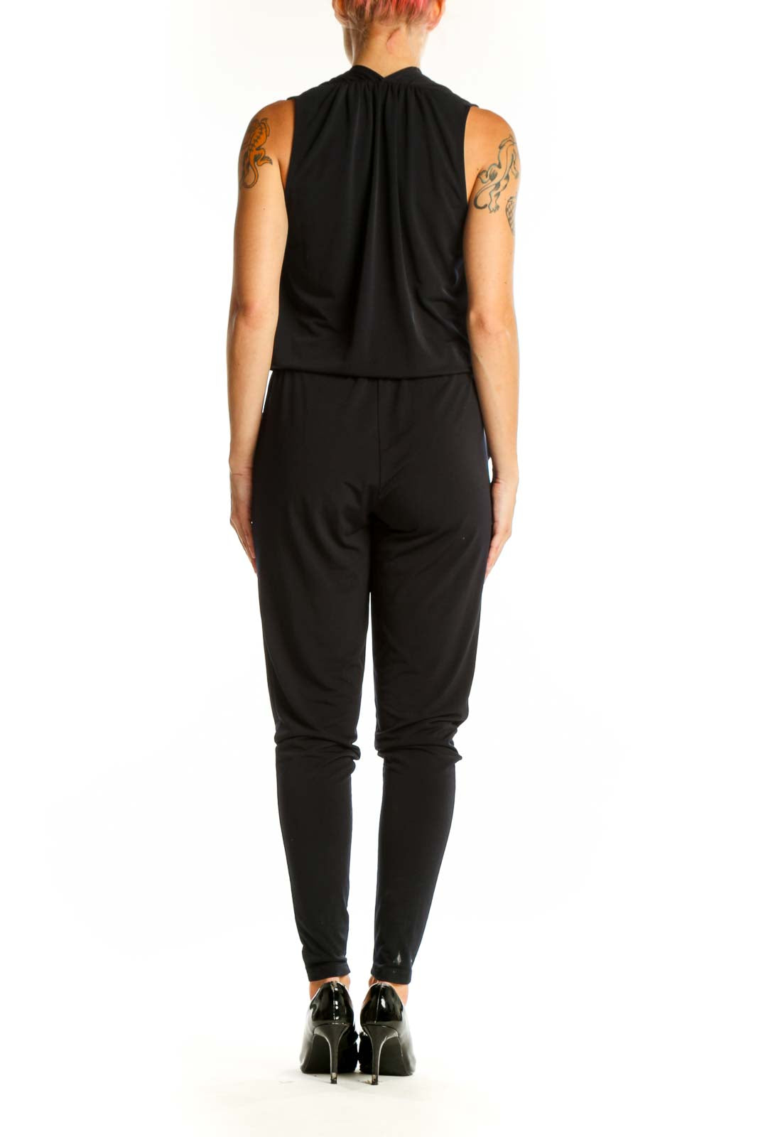 Side view of black MICHAEL Michael Kors jumpsuit showing tapered legs and sleeveless design