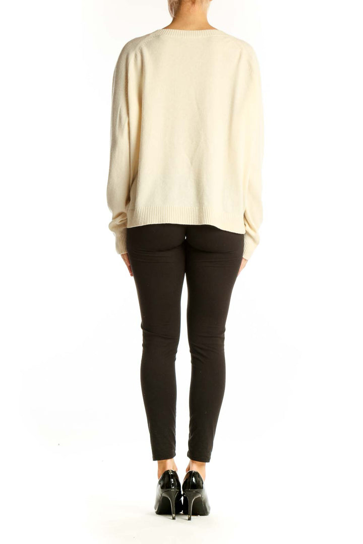 Back view of cream Vince cashmere oversized sweater on model with black pants