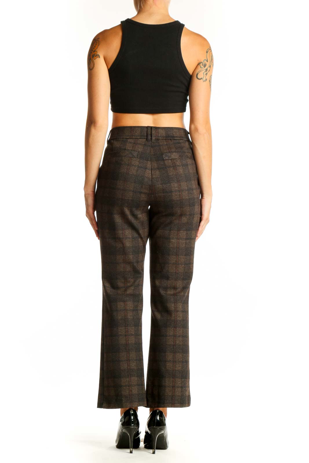 Side view of model wearing Democracy brown plaid trousers with black top