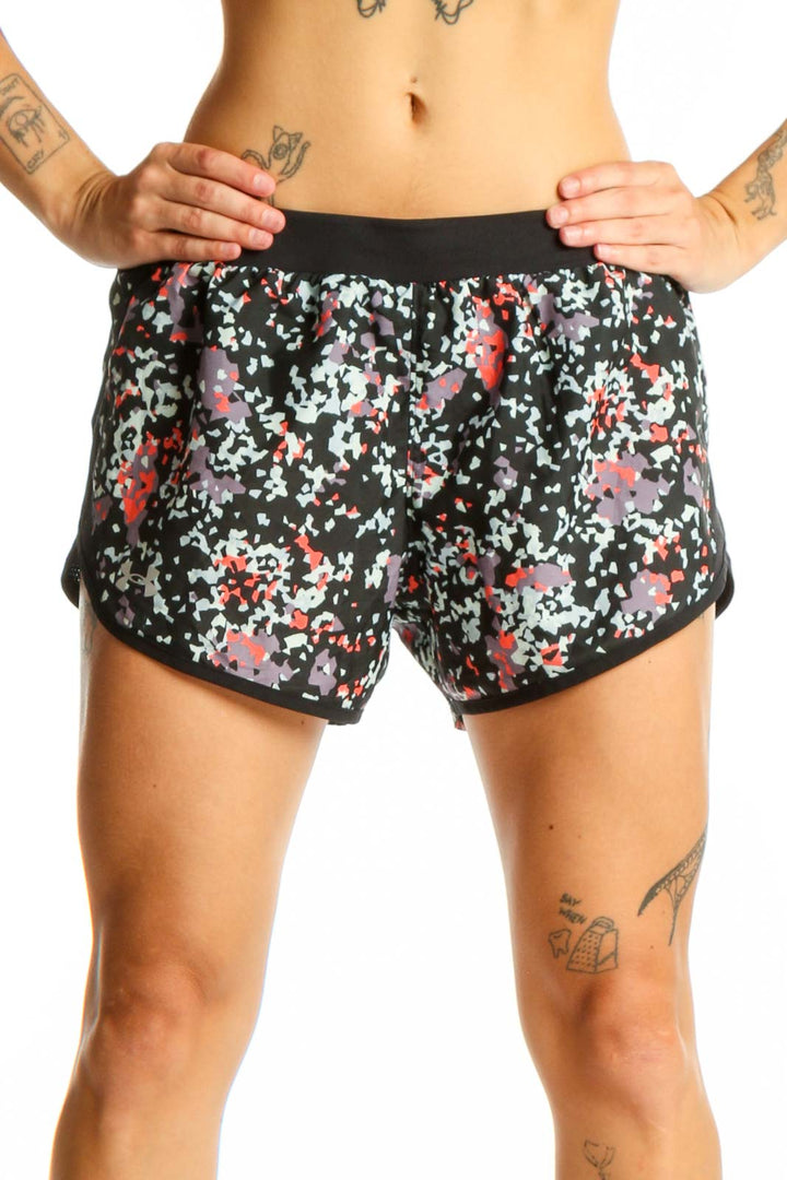 Front view of black floral print Under Armour athletic shorts