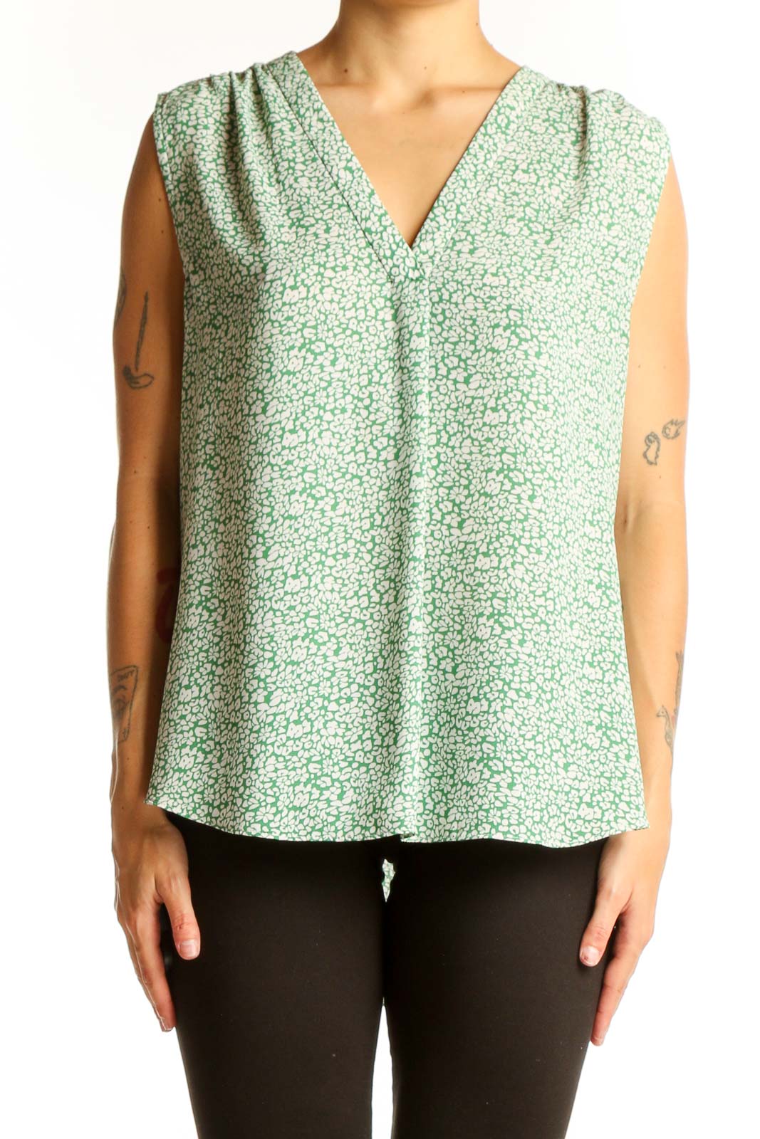 Front view of Vince Camuto green floral sleeveless blouse with V-neckline