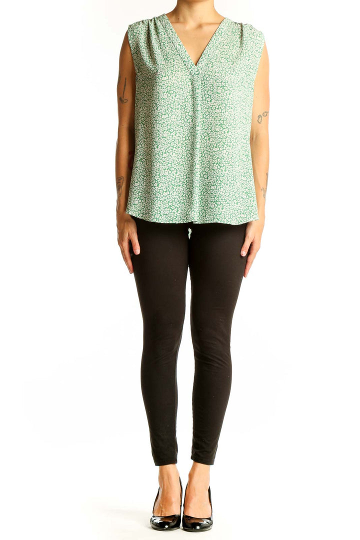 Front view of Vince Camuto green floral sleeveless blouse with V-neckline