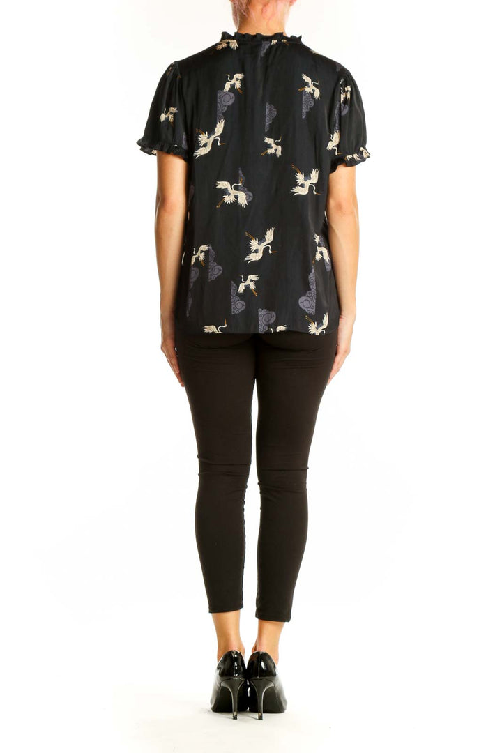Back view of Tahari black polyester blouse showing all-over crane and cloud print